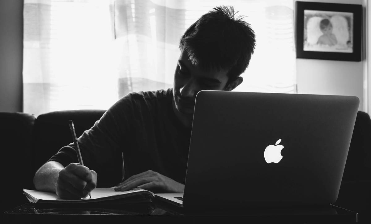 A calm introvert preparing notes before a virtual networking event, illustrating social skill networking how to improve